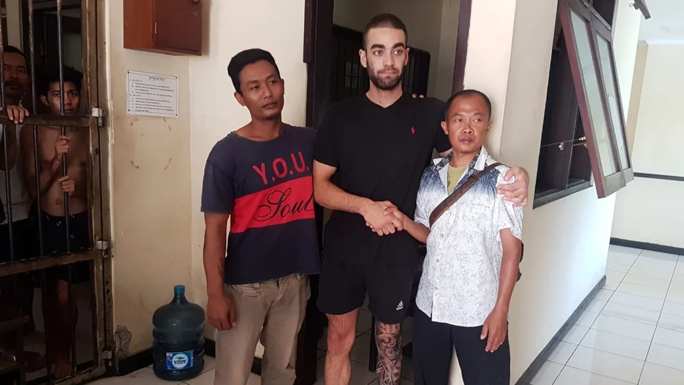 An Australian tradie accused of headbutting a taxi driver in Bali has celebrated his release from jail surrounded by family on his mother's birthday.