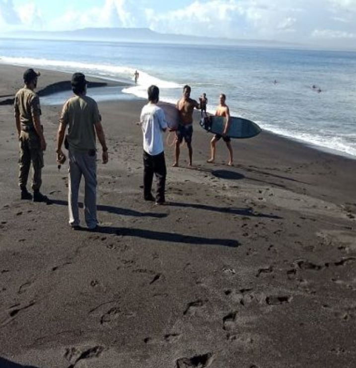 surfers check for covid-19 prevention on beach