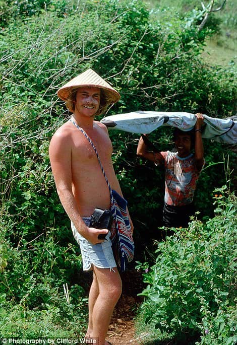 Balinese Local Carrying Clifford White’s Surf Board