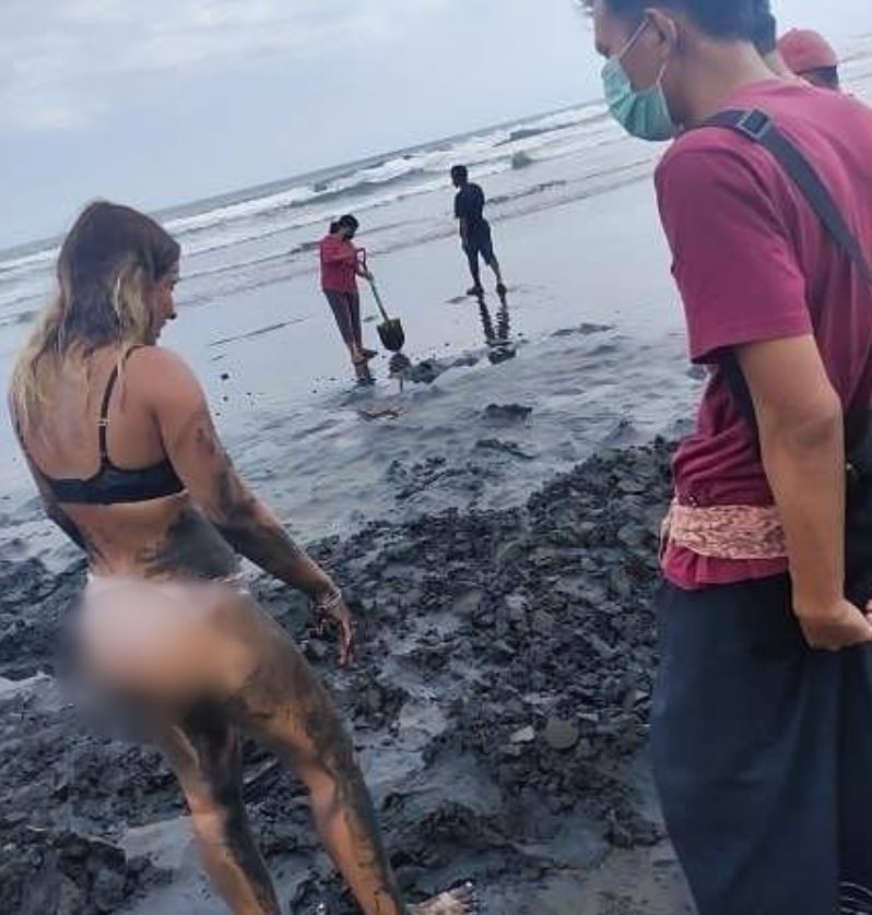 tourist searching for her phone at bali beach