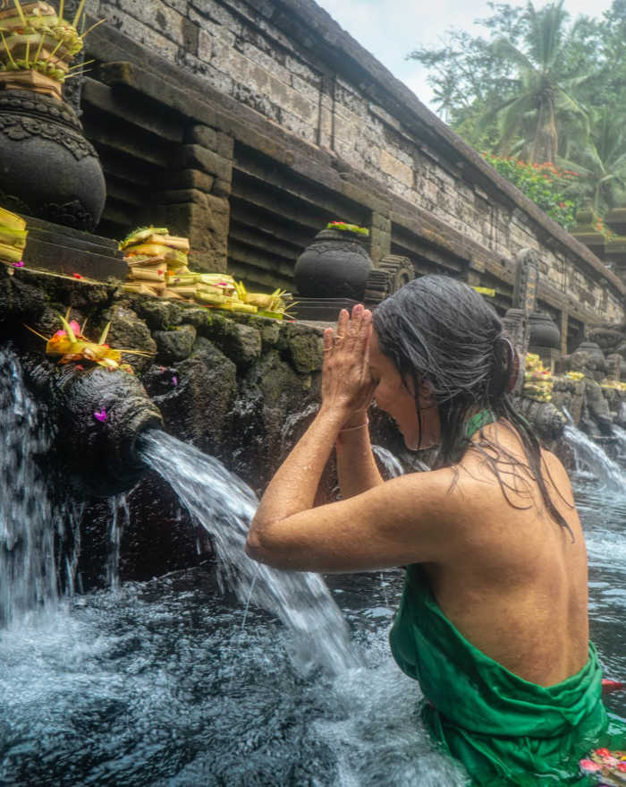 Australian Tourist prays in Bali fountain