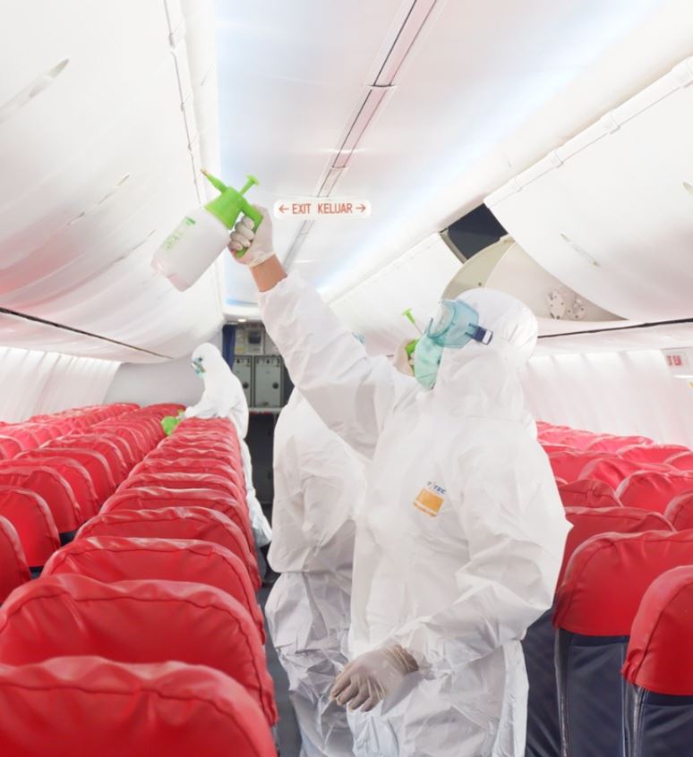 lion air plane being sanitized by men in hazmat suits
