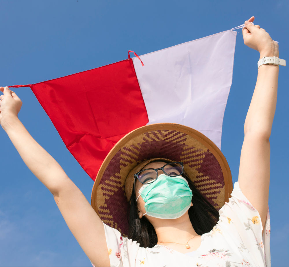 Woman in bali holding indonesia flag