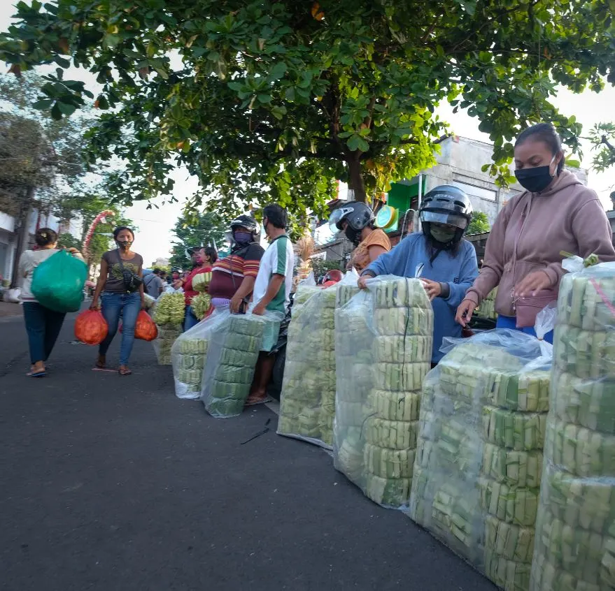 Bali locals giving away food wearing masks