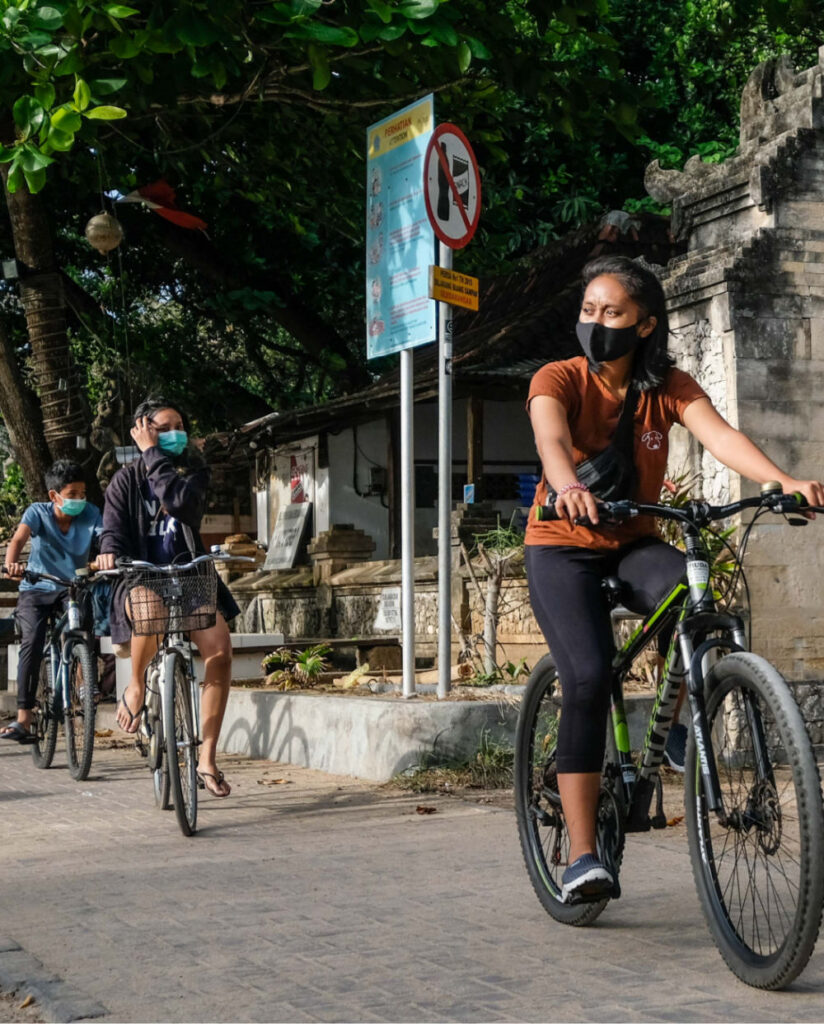 Bali locals on bikes wearing masks