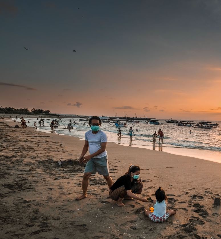 bali locals with masks at beach