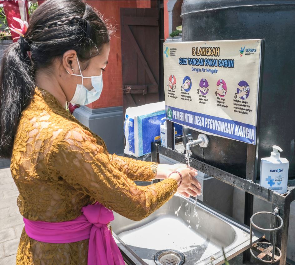 Bali resident washing hands wearing mask