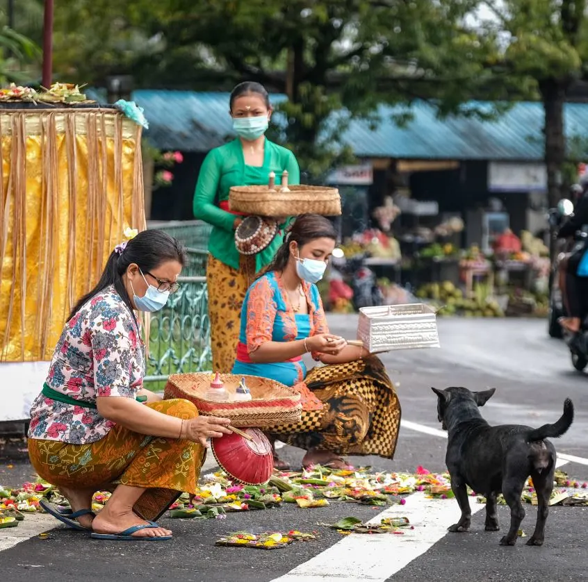 bali locals doing offerings in masks