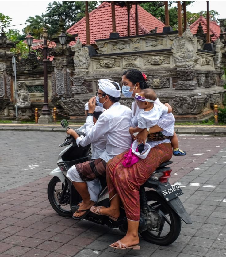 bali residents wearing masks on scooters