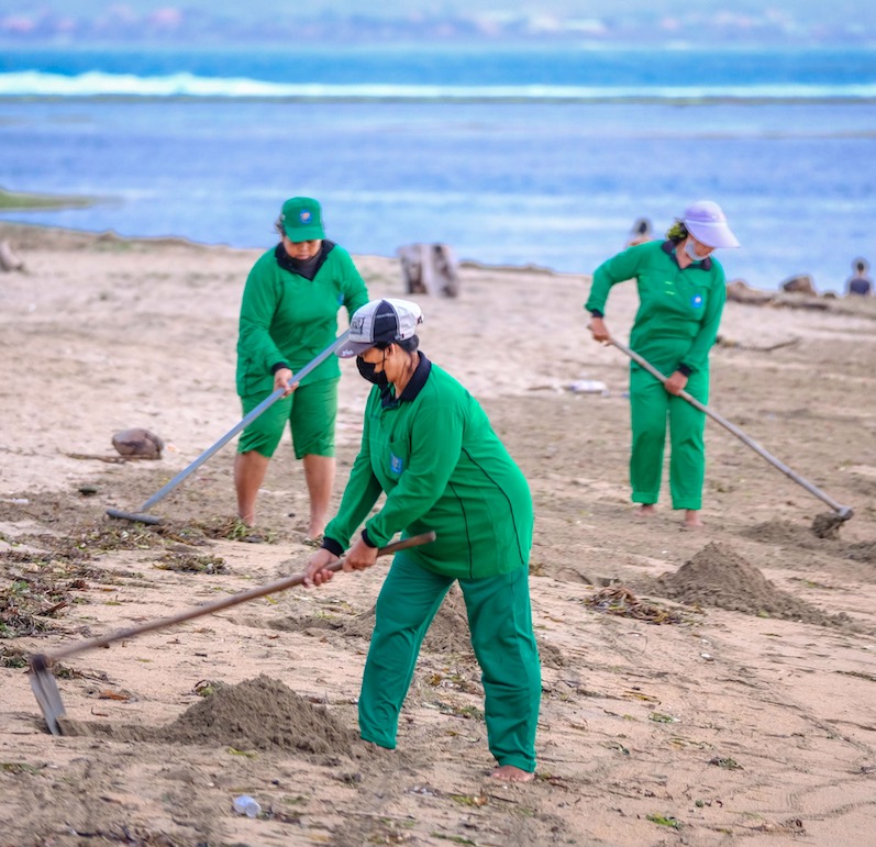 Bali staff cleaning beach