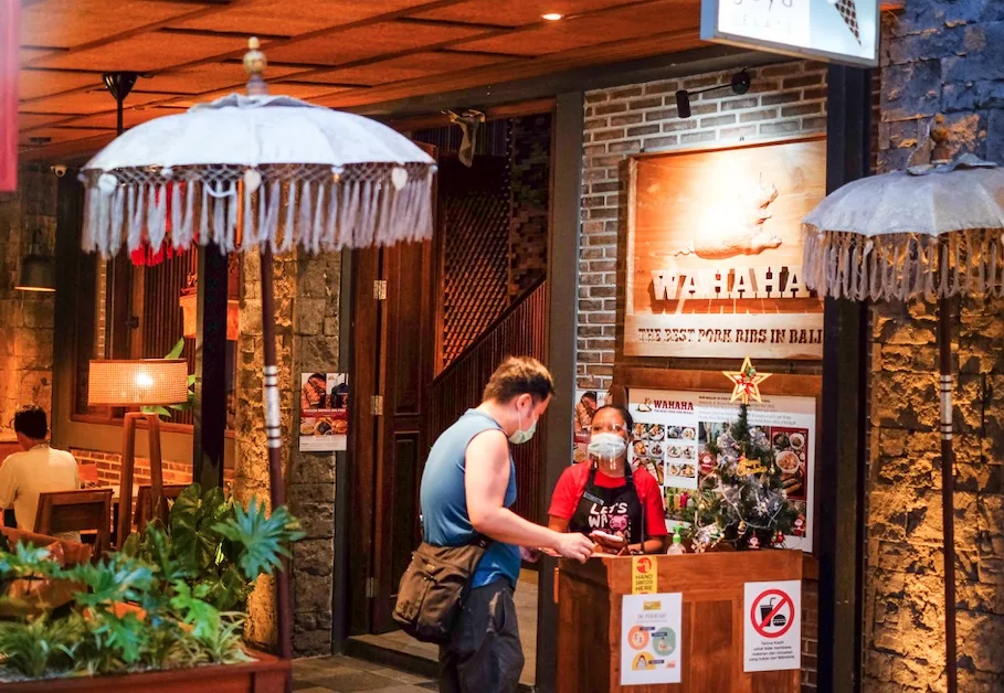 Restaurant staff in masks Covid safety protocols Bali