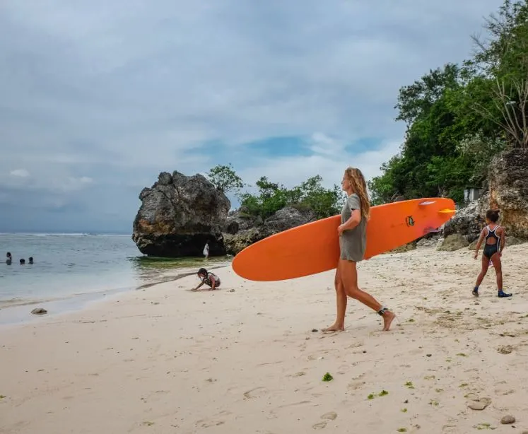 Tourist surfing at Bali beach