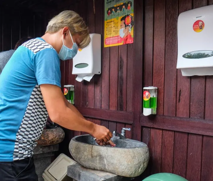 tourist at hand washing station