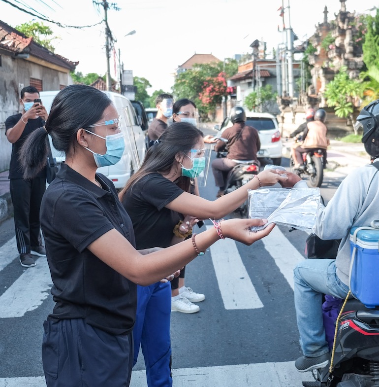 distributing masks in Bali