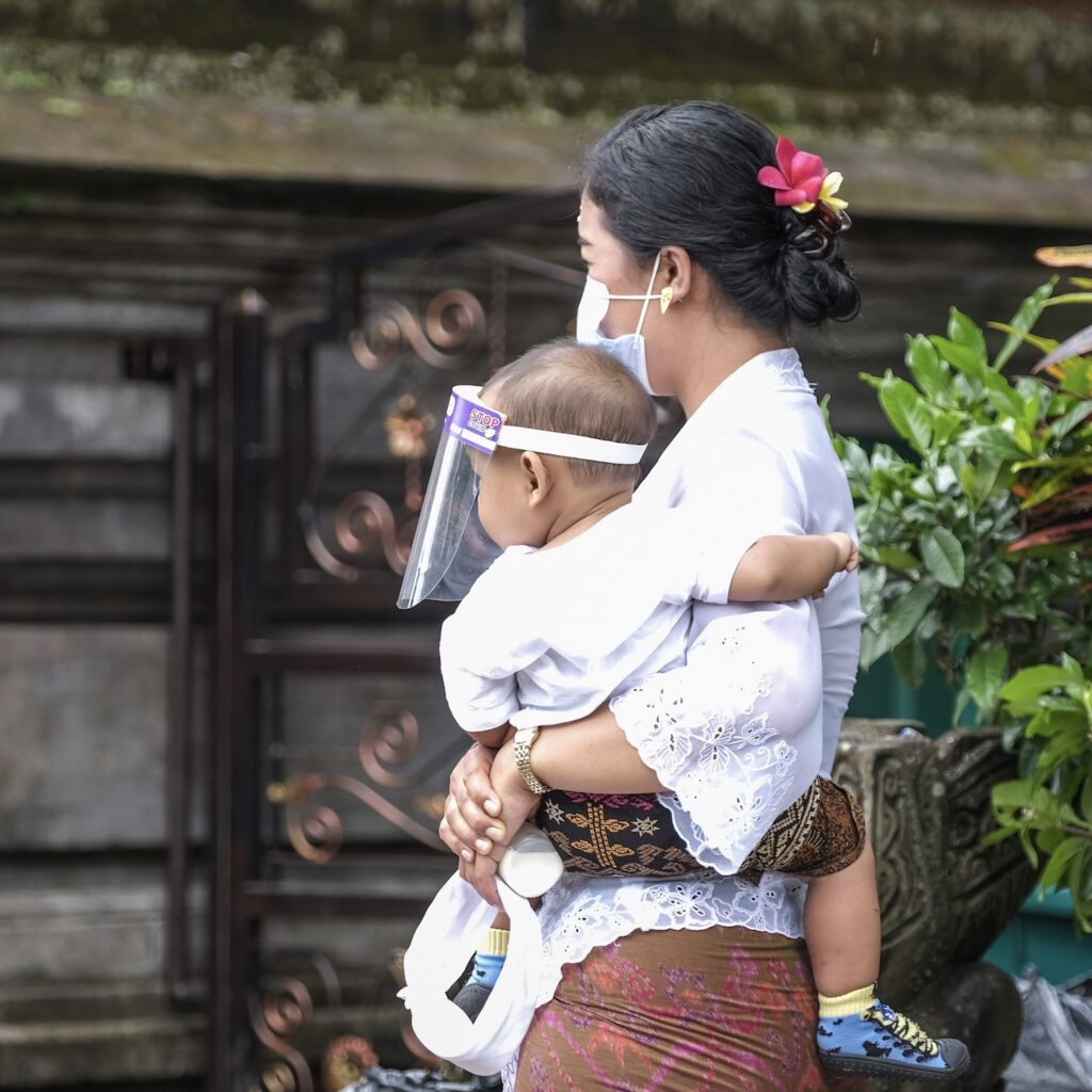 mother and baby in masks during pandemic in Bali