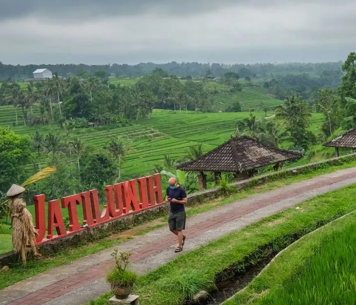 tourist walking in Bali mask