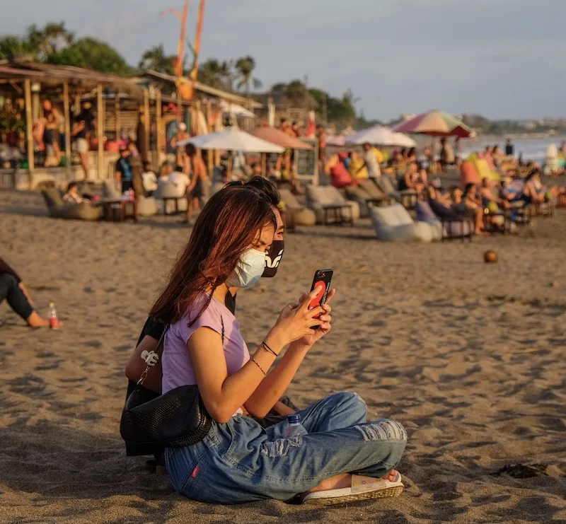 girl mask phone beach