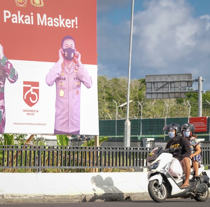 locals riding motorbike masks