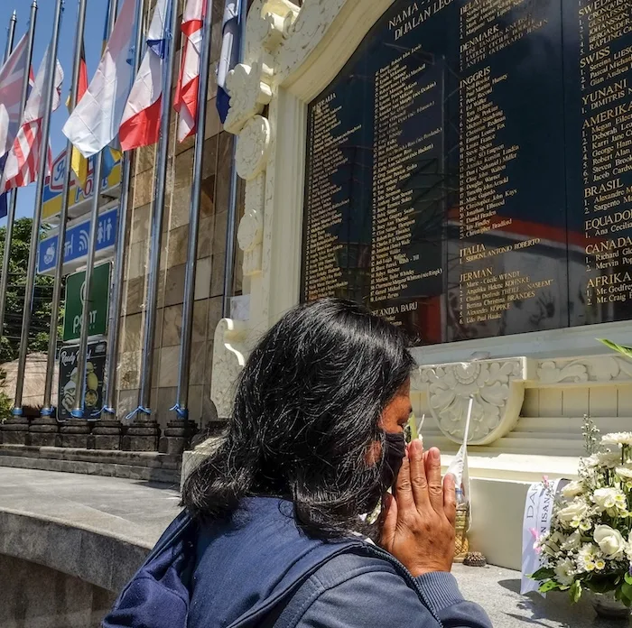 visitor praying at memorial