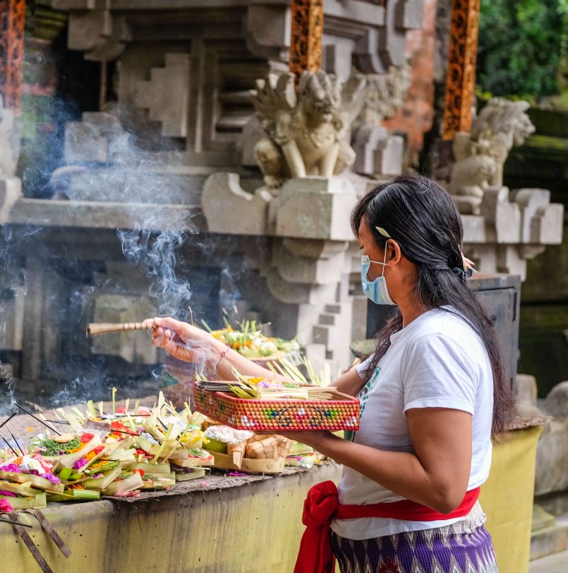 Bali Local in mask at offering