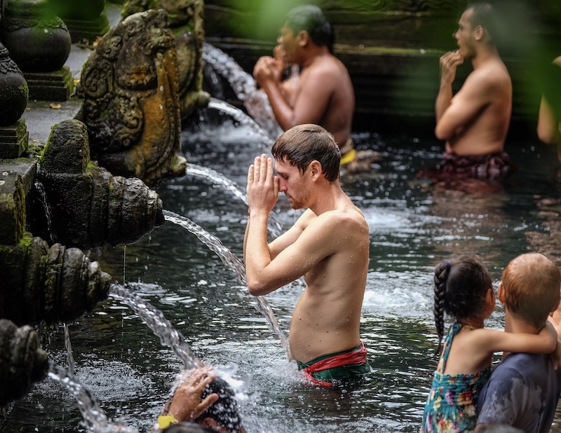 tourists praying Bali temple