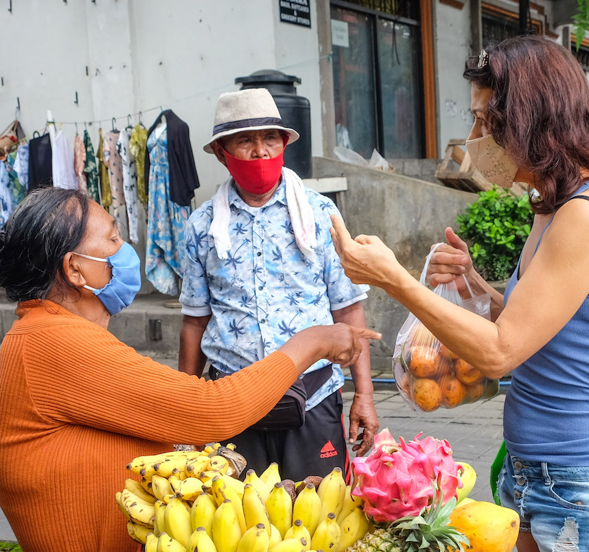 Bali tourist buying from roadside vendor