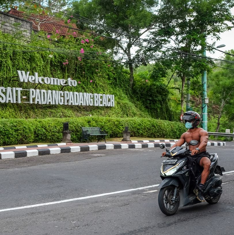 Bali tourist on motorbike empty road