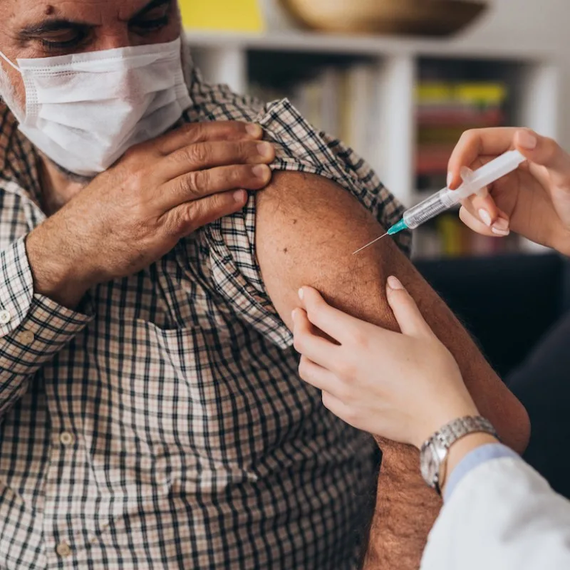 Senior citizen receiving COVID vaccine