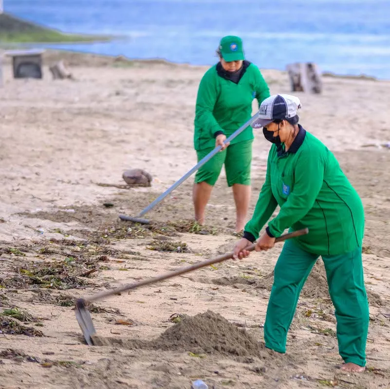 Locals cleaning waste from beach