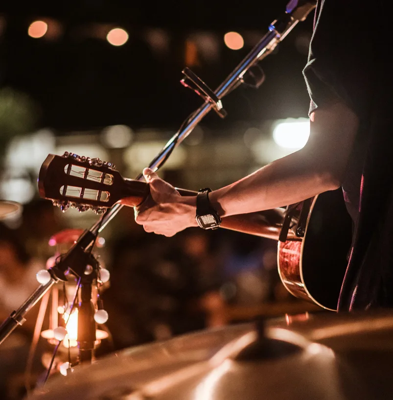 The musicians were playing rock music on stage, there was an audience full of people watching the concert. Concert,mini concert and music festivals. (The musicians were playing rock music on stage, there was an audience full of people watching the con