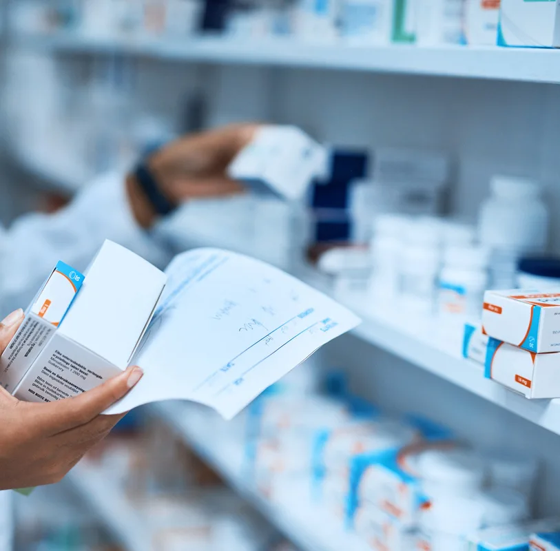 Cropped shot of a pharmacist filling a prescription at a chemist