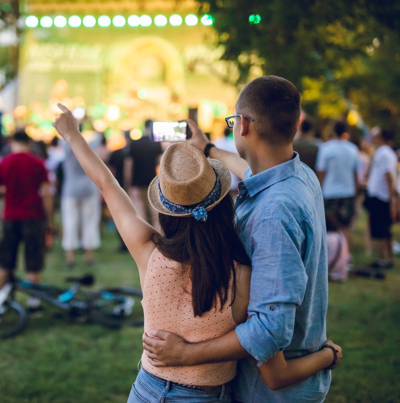 Young caucasian couple making selfie on a music festival.