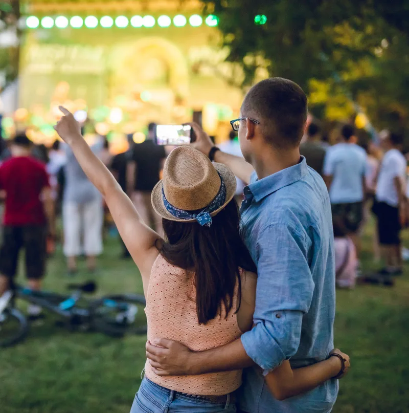 Young caucasian couple making selfie on a music festival.