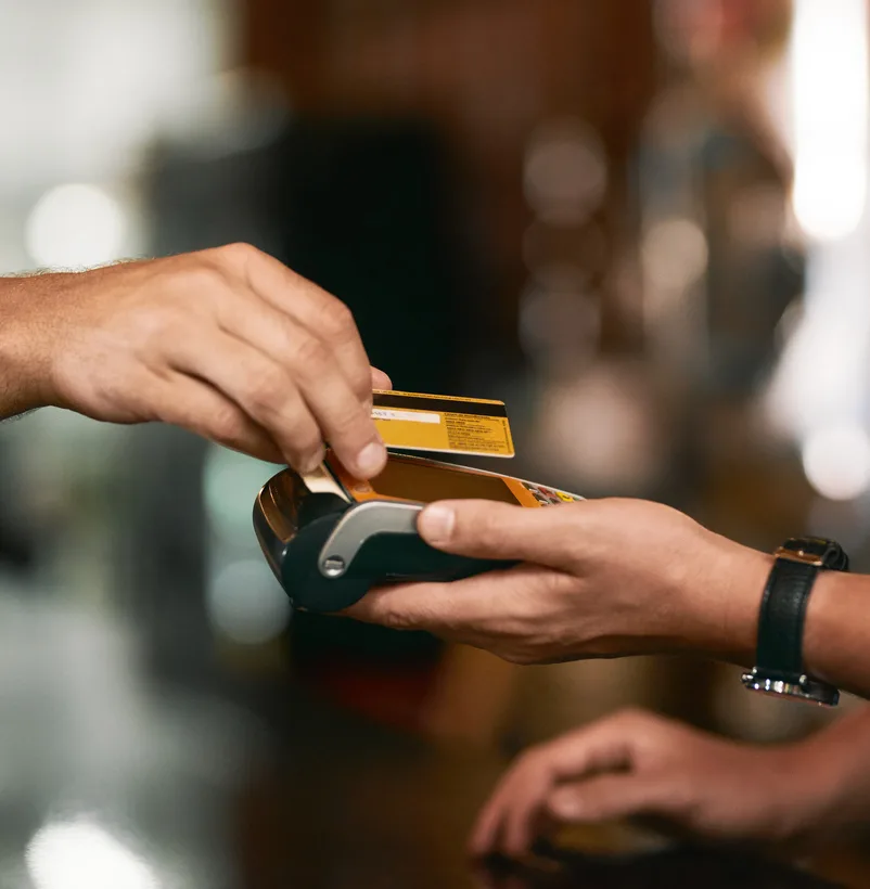 Shot of two unrecognizable people making an exchange in payment with a credit card 