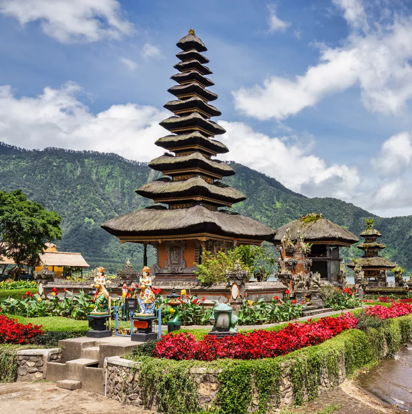 Balinese Ulun Danu Bratan Hindu Temple under blue summer sky at Lake Bratan. Pura Ulun Danu Beratan, or Pura Bratan, is a major Hindu Shaivite Shiva temple in Bali. The temple complex is on the shores of Lake Bratan in the mountains near Bedugul. Lake Bratan, Danau Beratan, Candikuning, Baturiti, Tabanan Regency, Bali Island, Indonesia, South-East Asia, Asia