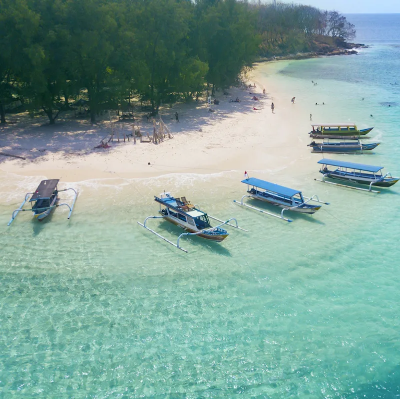 Image of tourist ships anchored on the Gili Rengit beach at Lombok, Indonesia