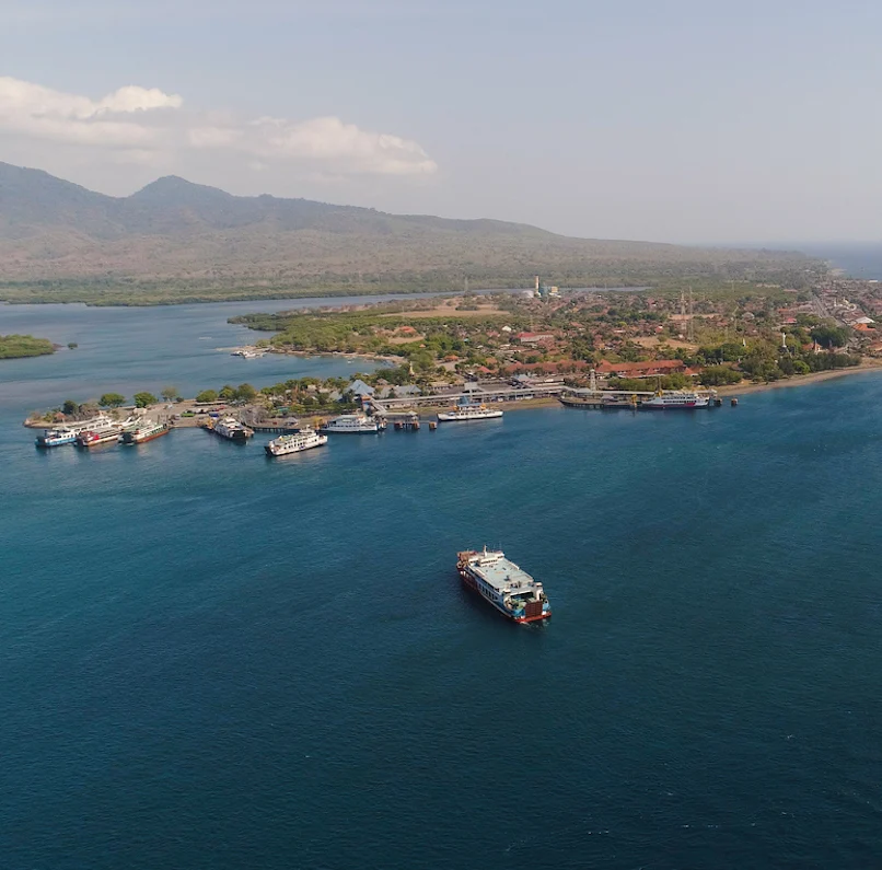 Aerial view ferry port gilimanuk with ferry boats, vehicles. Ferries transport vehicles and passengers in port. Port for departure from Bali to the island of Java.