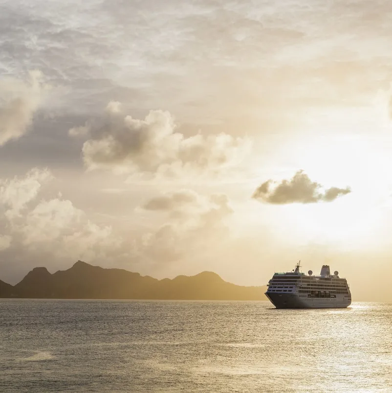 Cruise ship on the ocean at sunset
