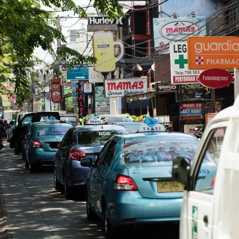 Blue-Bali-Taxis-In-Traffic-Jam-On-Tourist-Street