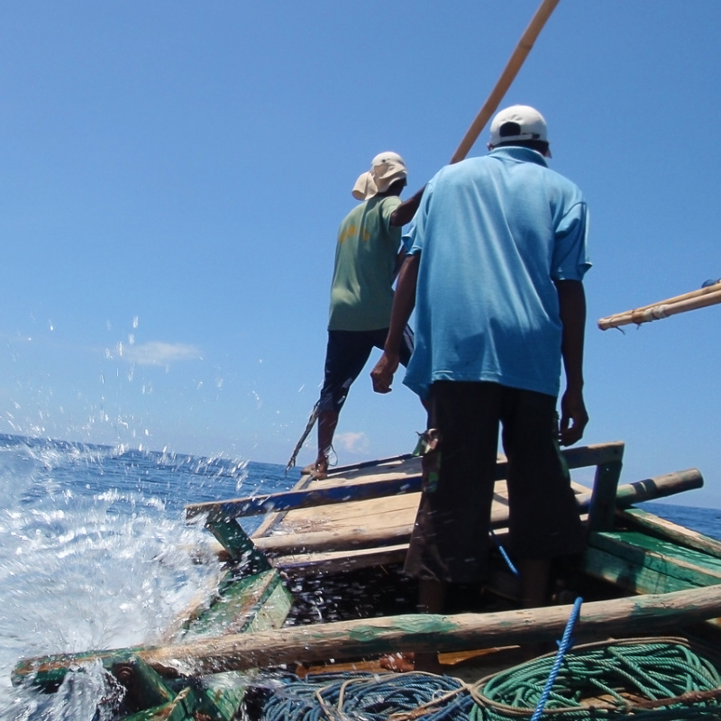 Indoneisan-Fisherman-Stand-In-Boat-Looking-for-Catch