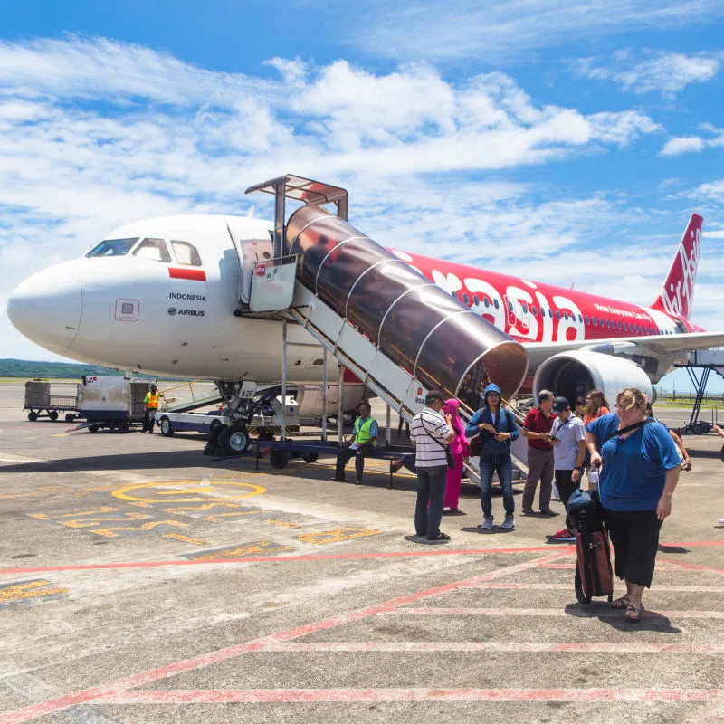 Toursts-Disembark-AirAsia-Plane-on-Bali-Runway