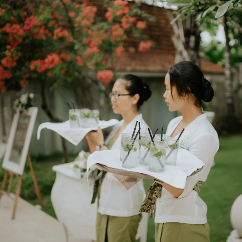 Two-Bali-Hotel-Hostesses-Hold-Trays-Of-Welcome-Drinks