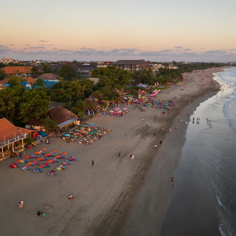 Ariel-View-of-Seminyak-Beach-Busy-With-Tourists-At-Sunset