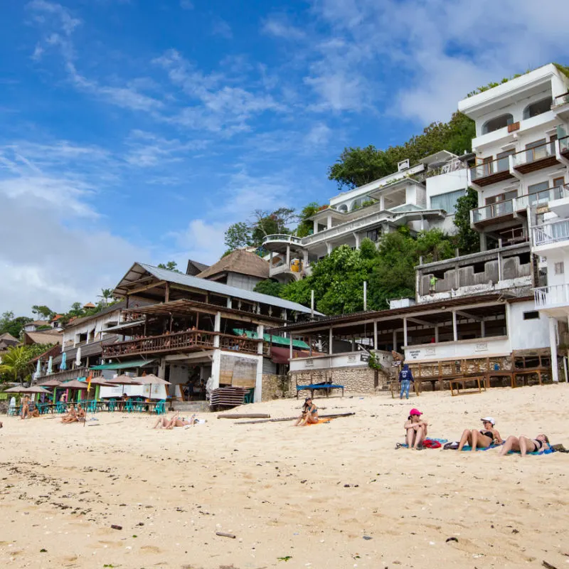 Beachside-Hotels-In-South.-Bali-With-Tourists-Sunbathing