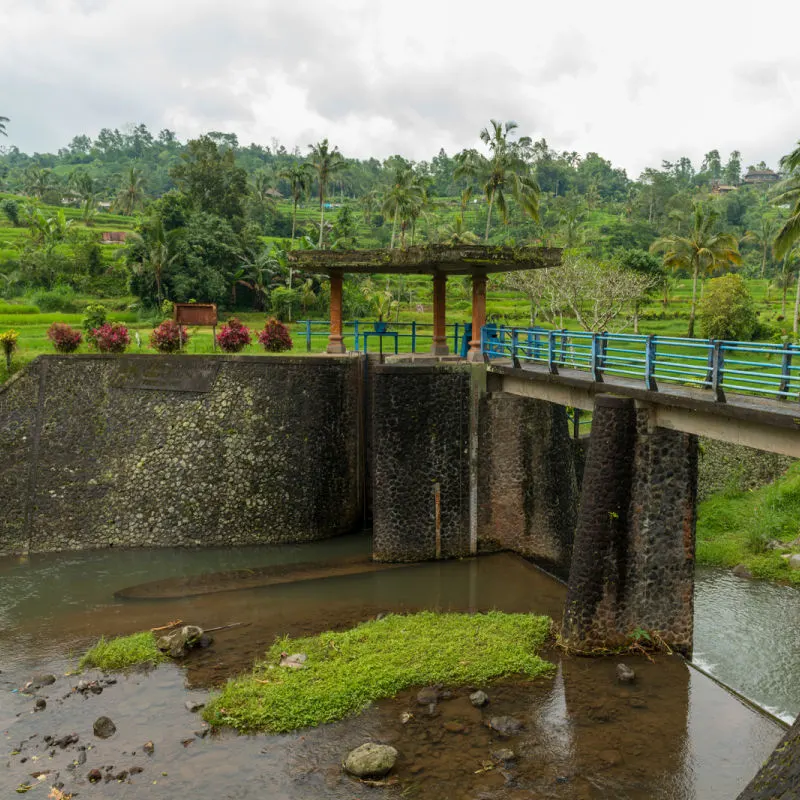 Empty Water Dam Along Bali River Waterway By Rice Fields