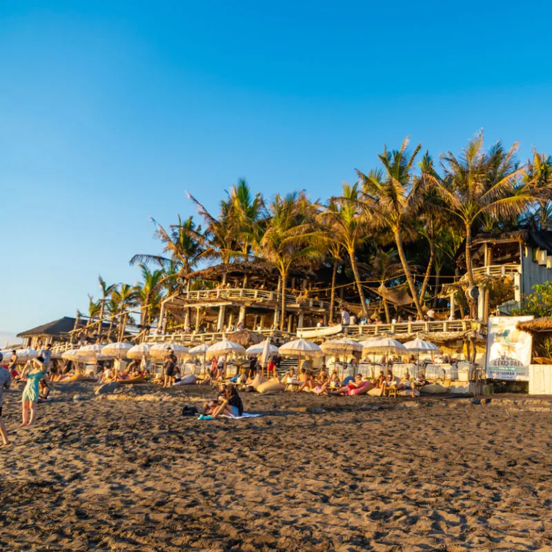 beach with tourists on it looking out at the ocean