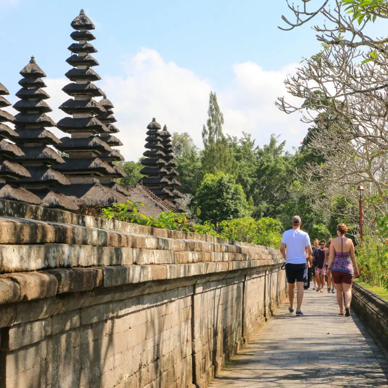 Tourists Walk Through Tourism Village In Bali