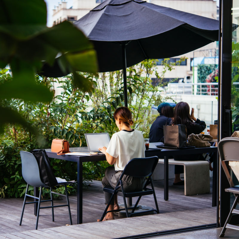 Woman-Works-On-Her-Laptop-At-Coffee-Shop-Terrace