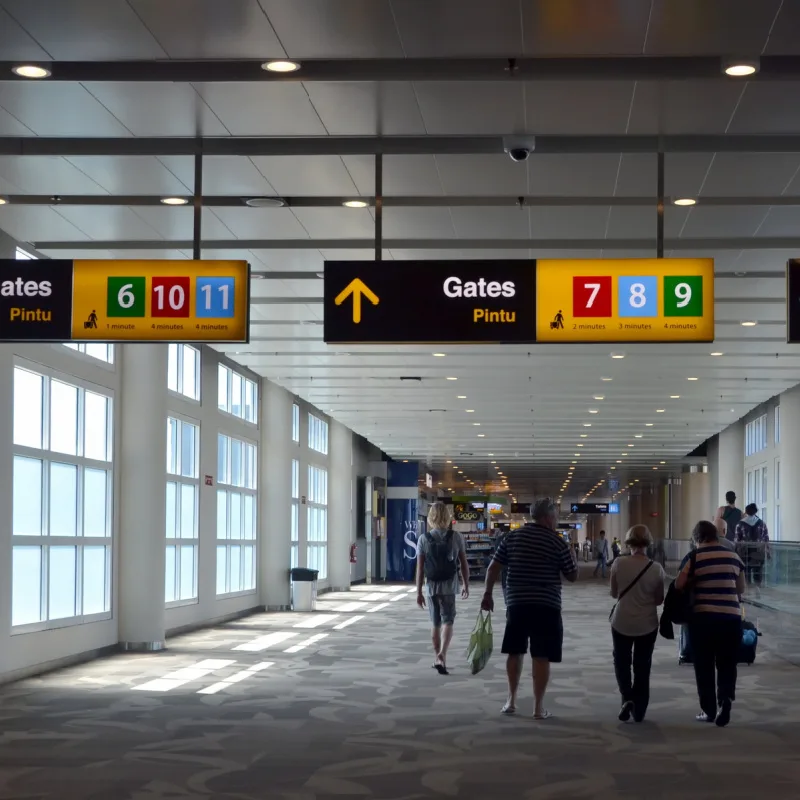 Travelers walk to the departure gates at Bali Airport