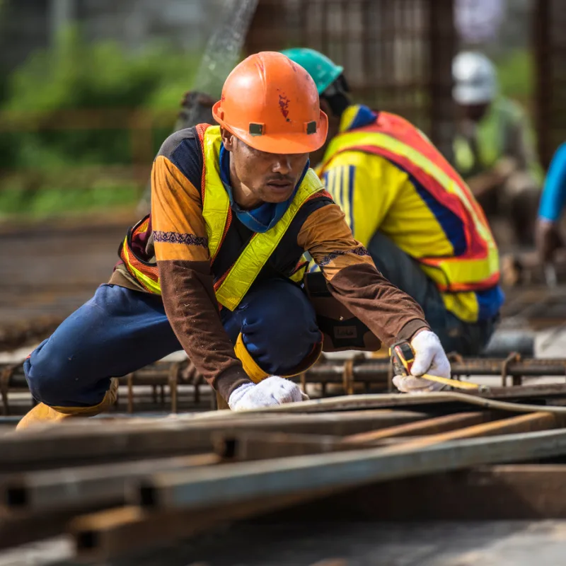 Construction-Worker-In-Bali-Works-With-Metal-Rodspg